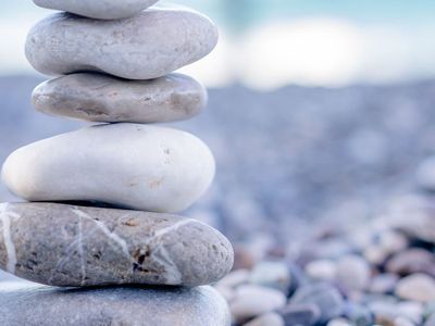 A stack of perfectly balanced stones on a beach.